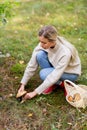 Young woman picking mushrooms in autumn forest Royalty Free Stock Photo