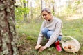 Young woman picking mushrooms in autumn forest Royalty Free Stock Photo