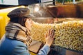 Young woman picks popcorn at the cinema. food and snacks.