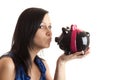 Young woman piggy bank kissing Royalty Free Stock Photo