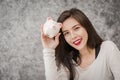 Young woman with piggy bank in the room Royalty Free Stock Photo