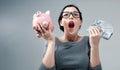 Young woman with a piggy bank with us dollar bills Royalty Free Stock Photo