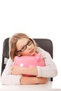 Young woman with piggybank on the desk Royalty Free Stock Photo