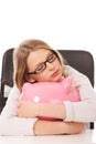 Young woman with piggybank on the desk Royalty Free Stock Photo