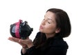 Young woman piggybank kiss