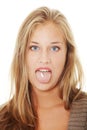 Young woman with pill in her mouth Royalty Free Stock Photo