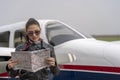 Young Woman Pilot Reading a Map
