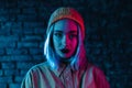 Young woman in pink and blue neon light. Portrait of unusual beautiful punk girl Royalty Free Stock Photo