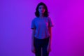 Young woman in pink blue neon lights. Creative colorful portrait