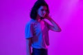 Young woman in pink blue neon lights. Creative colorful portrait