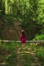 The young woman in forest. Back view