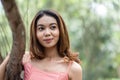 Young woman in pink dress enjoying the tranquil scenery with bokeh park background Royalty Free Stock Photo