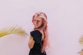 Young woman with pink hair playfully looking over her shoulder. Portrait of wonderful tanned girl i Royalty Free Stock Photo