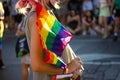 Woman, pink-haired girl holding a rainbow LGBT flag on Pride Month. Lesbian, gay