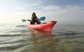 Young woman in pink kayak