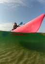 Young woman on pink kayak