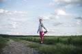 Young woman in pink leggings stretching and warming up before going for a run