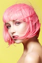 Young woman in pink wig. Beautiful model with fashion makeup. Bright spring look. hair color, medium hairstyle Royalty Free Stock Photo