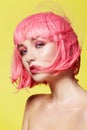 Young woman in pink wig. Beautiful model with fashion makeup. Bright spring look. hair color, medium hairstyle Royalty Free Stock Photo