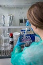 Young woman pipetting sample for analyzing results after human