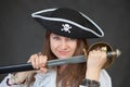 Young woman pirate gets a sabre from sheath