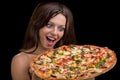 Young woman with pizza against black background Royalty Free Stock Photo