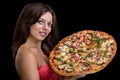 Young woman with pizza against black background Royalty Free Stock Photo