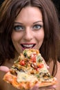 Young woman with pizza against black background Royalty Free Stock Photo