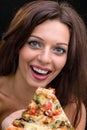 Young woman with pizza against black background Royalty Free Stock Photo