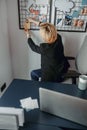 Young woman placing notes on mood board in the office Royalty Free Stock Photo