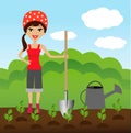 A young woman plants a nursery transplant in soil