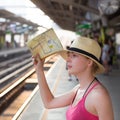 Young woman on platform of railway station. Royalty Free Stock Photo