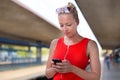 Young woman on platform of railway station. Royalty Free Stock Photo