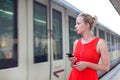 Young woman on platform of railway station. Royalty Free Stock Photo