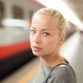 Young woman on platform of railway station. Royalty Free Stock Photo