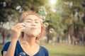 Young woman play blowing bubble outdoor lifestyle vintage color Royalty Free Stock Photo