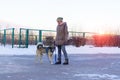 Young woman play with dog walking with snow on Winter. selective focus Royalty Free Stock Photo