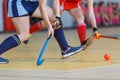 Young woman player in attack at indoor hockey match