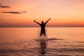 Young women jumping splashing water on the beach Royalty Free Stock Photo