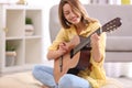 Young woman playing acoustic guitar Royalty Free Stock Photo