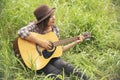 Young women playing acoustic guitar outdoor in green park. Woman person playing acoustic guitar music instrument at home, young Royalty Free Stock Photo