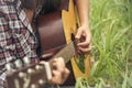 Young women playing acoustic guitar outdoor in green park. Woman person playing acoustic guitar music instrument at home, young Royalty Free Stock Photo