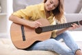 Young woman playing acoustic guitar Royalty Free Stock Photo