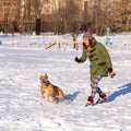 Young woman playing with American Pit Bull Terrier in winter Royalty Free Stock Photo