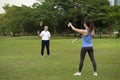 young woman playing badminton with senior man in the park Royalty Free Stock Photo