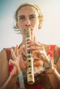 Young woman playing bamboo flute on summer day Royalty Free Stock Photo