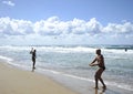 Young woman playing beach tennis on Sabaudia beach.