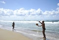 Young woman playing beach tennis on Sabaudia beach.