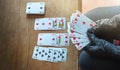 Young woman playing  cards alone at home wearing medical gloves,solitare ,while confined at home Royalty Free Stock Photo