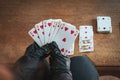 Young woman playing  cards alone at home wearing medical gloves,solitare ,while confined at home Royalty Free Stock Photo